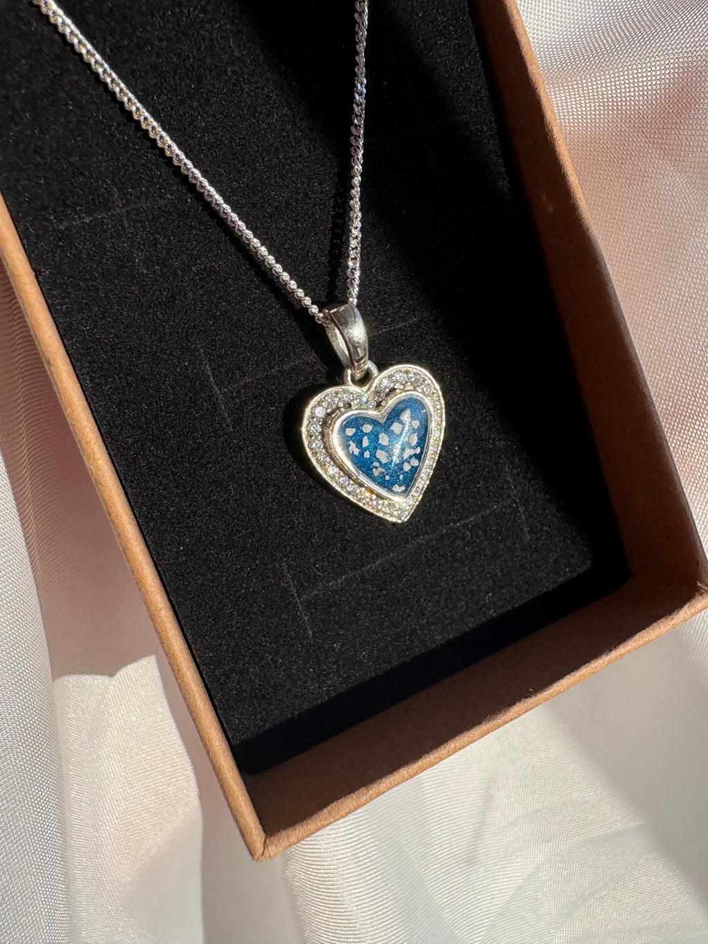 S925 heart pendant, with ashes set in a blue stone.