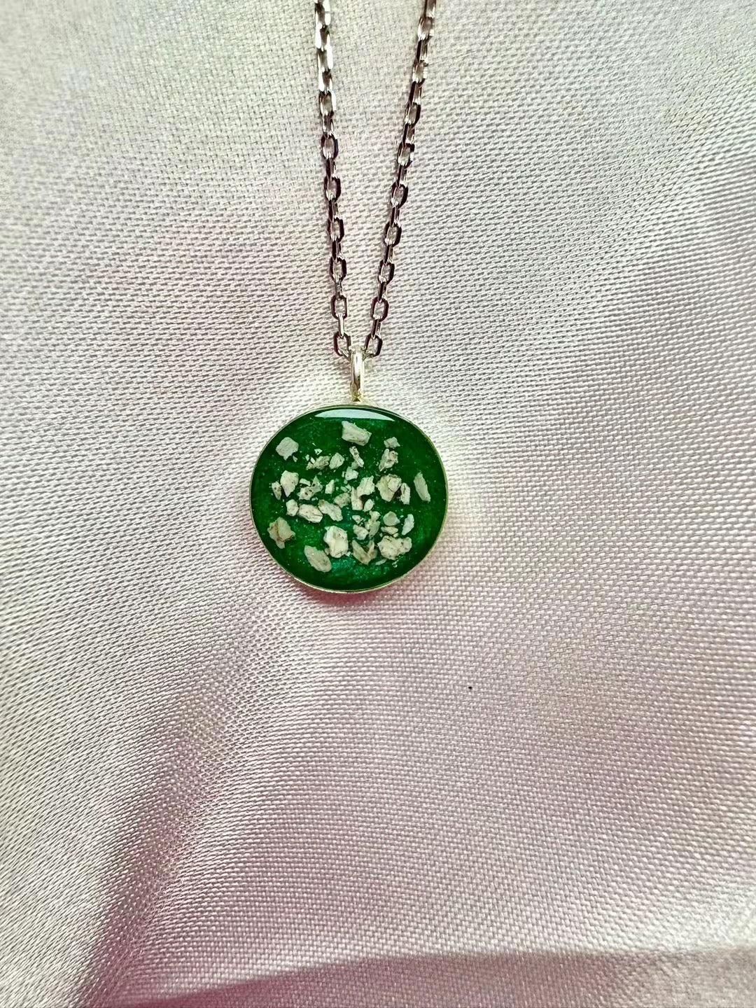 S925 round pendant, with ashes set in a green stone.